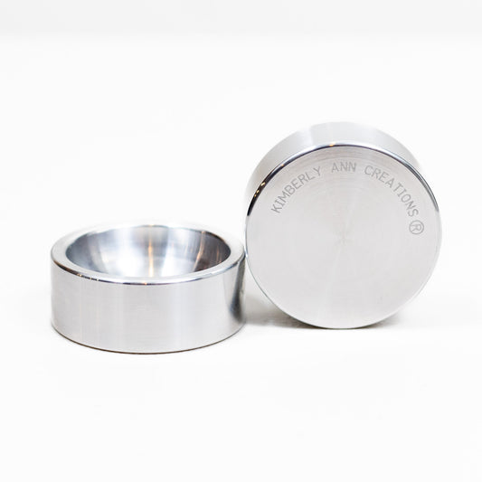 Two solid aluminum 2 inch smooth-edge ring dishes on white, one upright and one on its side showing the engraved base