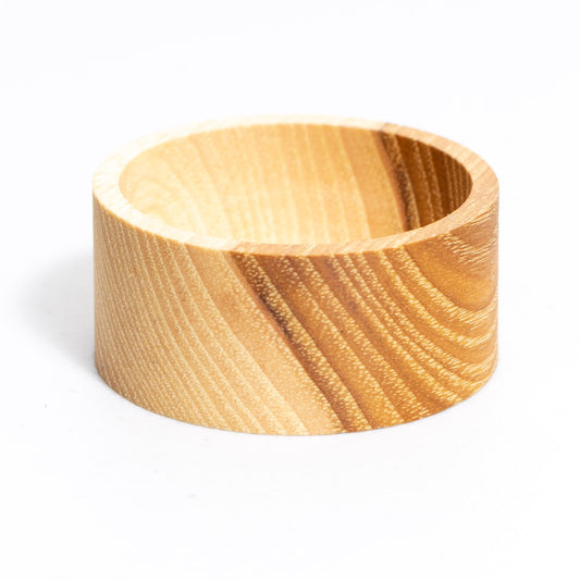 Empty solid hickory 2 inch round ring dish, front view on white showing light and dark grain